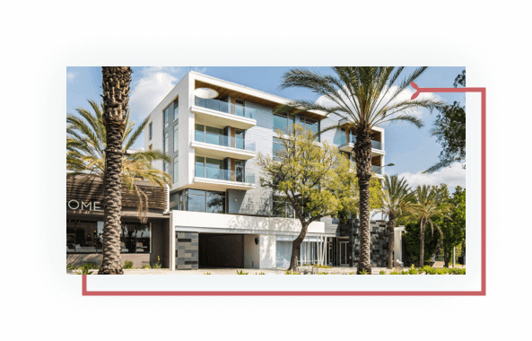 Street-level view of Pasadena building, stairs, awning, glass entrance
