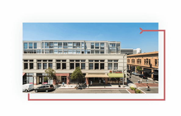 Multi-level Pasadena building, cars, pedestrians, bicyclists